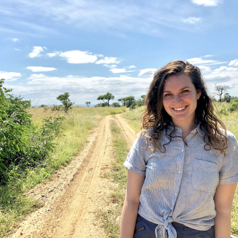 NHC PGH member Emily smiling on a sunny day in the countryside 