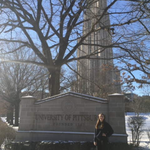 NHC PGH member Mary Margaret standing in front of a University of Pittsburgh sign