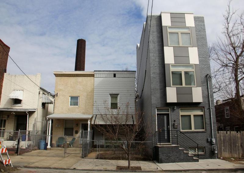 four row homes in east kensington with one that stands out as new development increases
