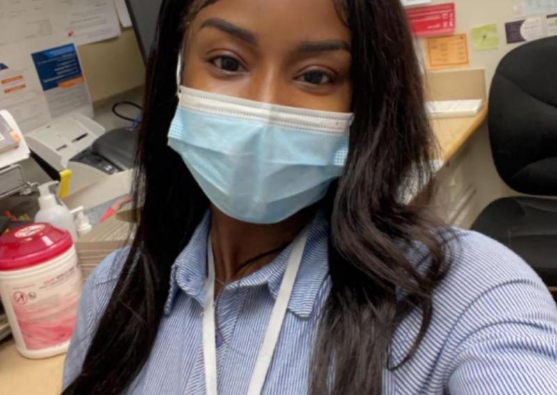 A selfie of Ami wearing a blue medical mask