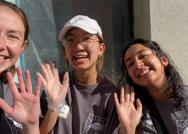 three people are in the photo - Catherine (left), Fern (middle), Rachel (right). All three are waving at the camera and smiling. 
