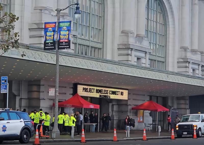 A photo of the entrance of Bill Graham Civic Auditorium. On the sign at the front of the entrance reads "Project Homeless Connect."