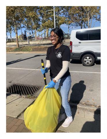 Anisha participates in a litter cleanup.