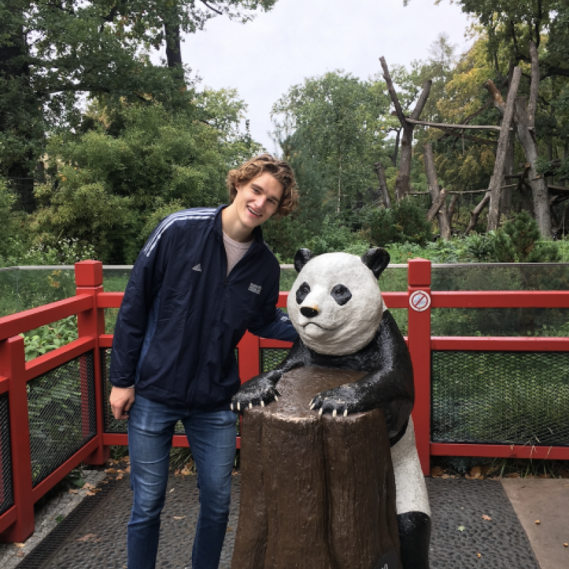 NHC PGH member Nate smiling posing with a panda statue
