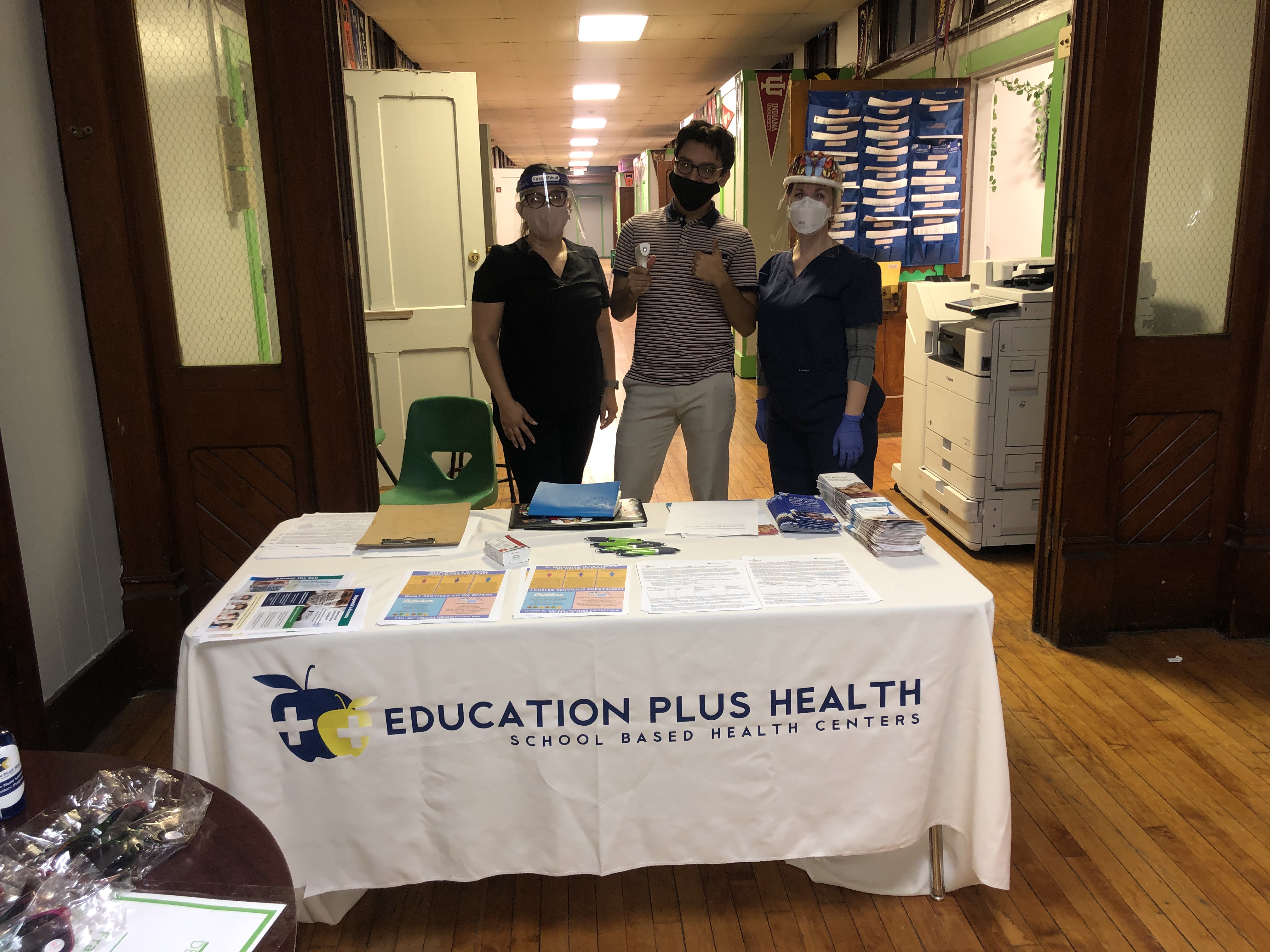 The School-Based Health Center Licensed Practical Nurse, Community Health Worker, and Nurse Practitioner prepared for community flu vaccination clinics at Deep Roots Charter School.