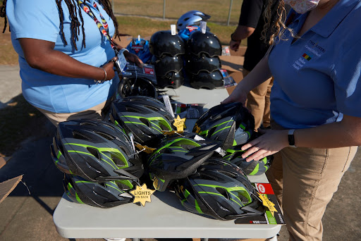 "Pictured are Bike Helmets being set up to give away to students at Windy Hill Elementary School after they get the helmet properly fitted. "