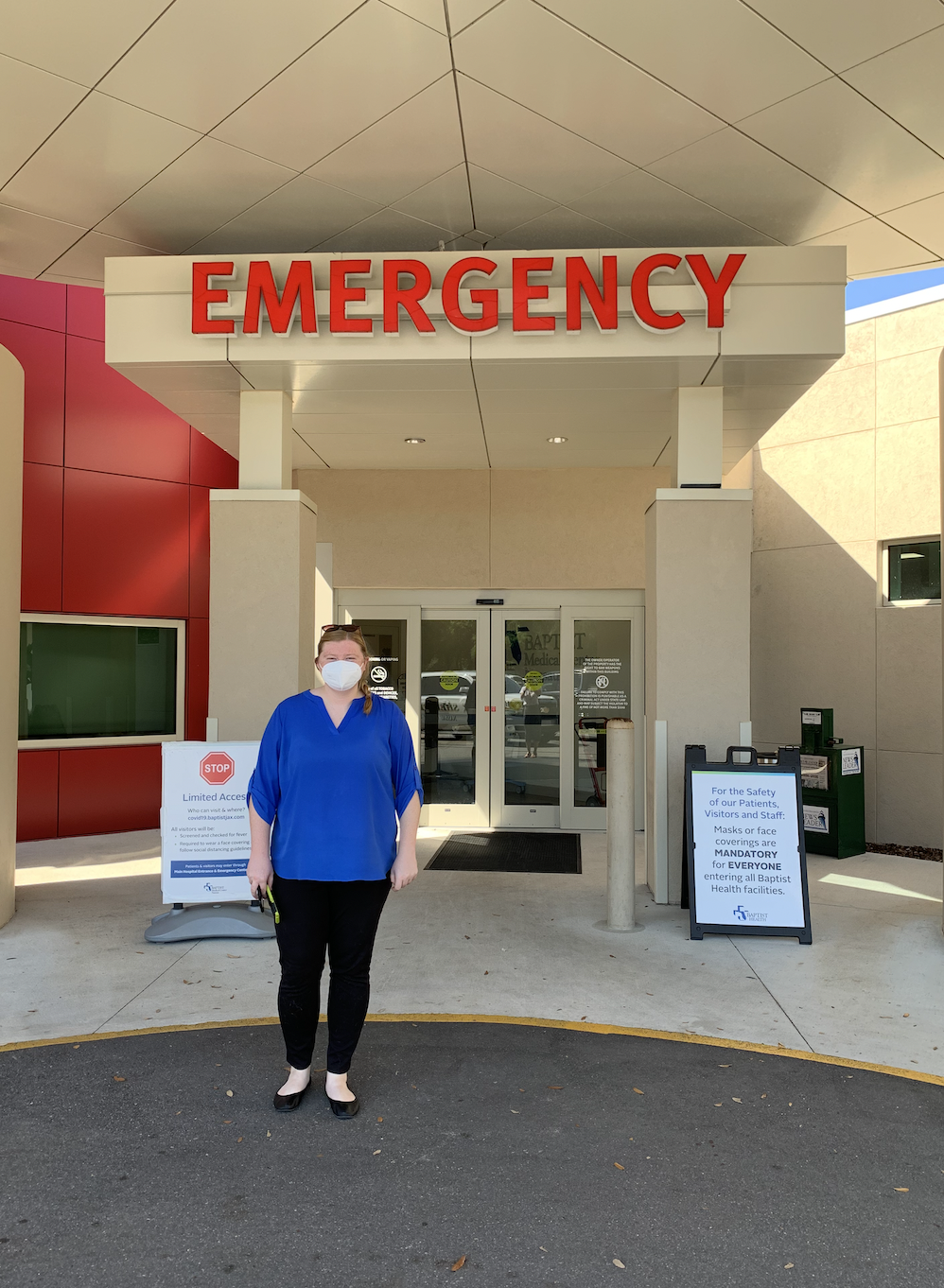 Paige standing outside of the hospital emergency room where she receives referrals from