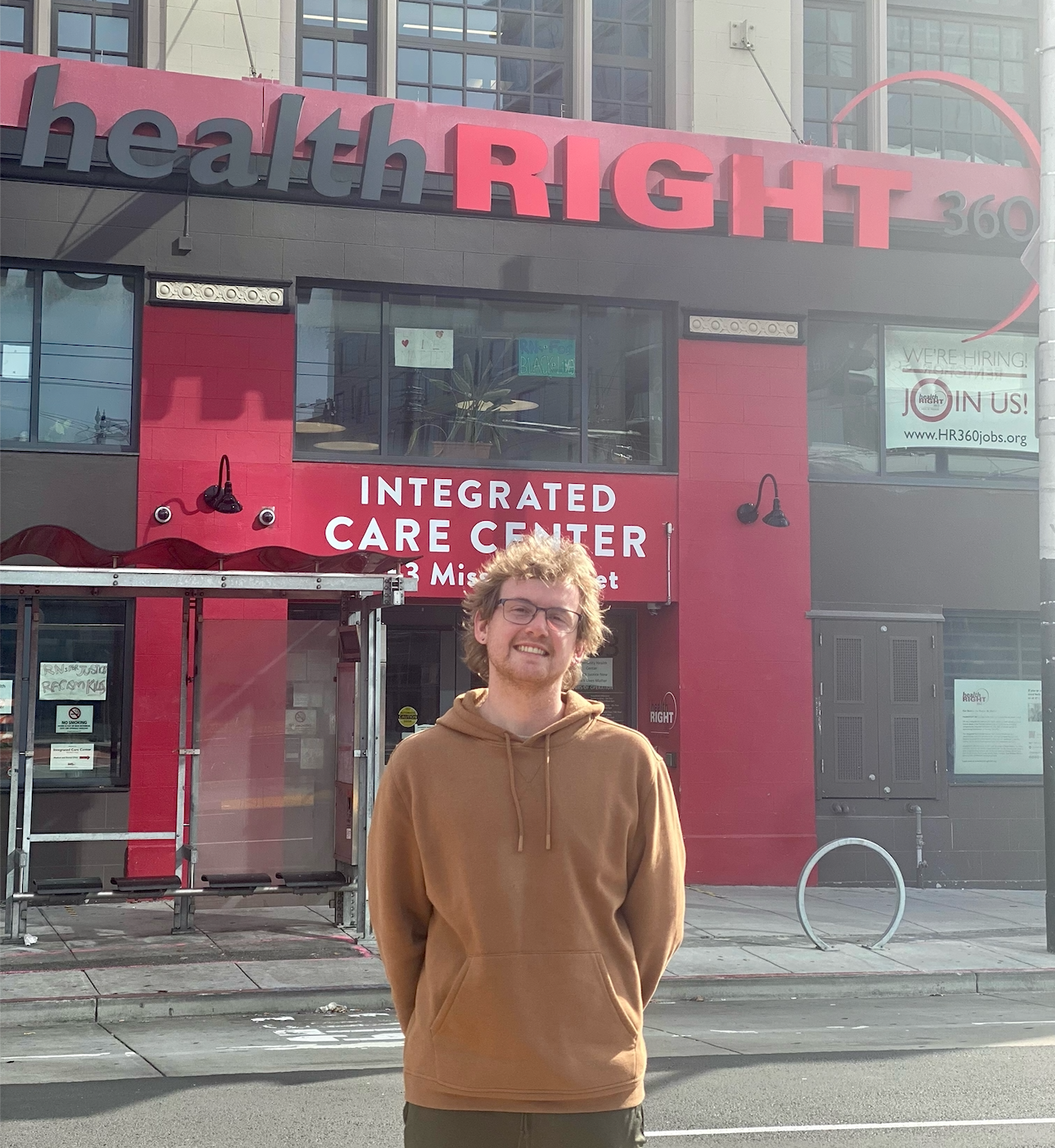 Will Crews stands in front of HealthRIGHT 360's front entrance. 