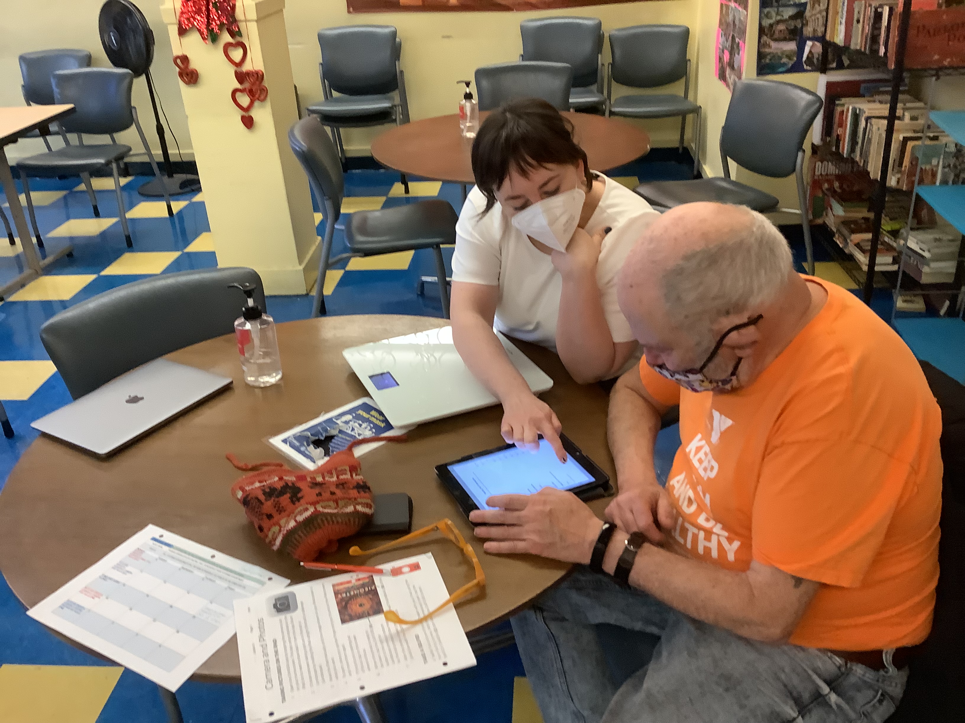 Hannah is seen here walking one of Curry Senior Center's clients through using their iPad during a tech support session.