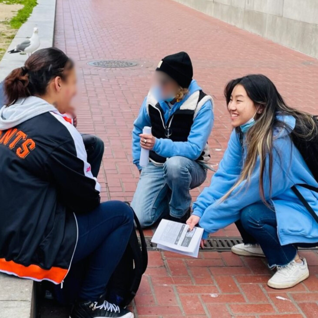 Vivian (right) and another outreach worker (middle) speak with a patient (left). 