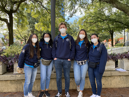 a group of 5 NHC members standing side by side wearing masks