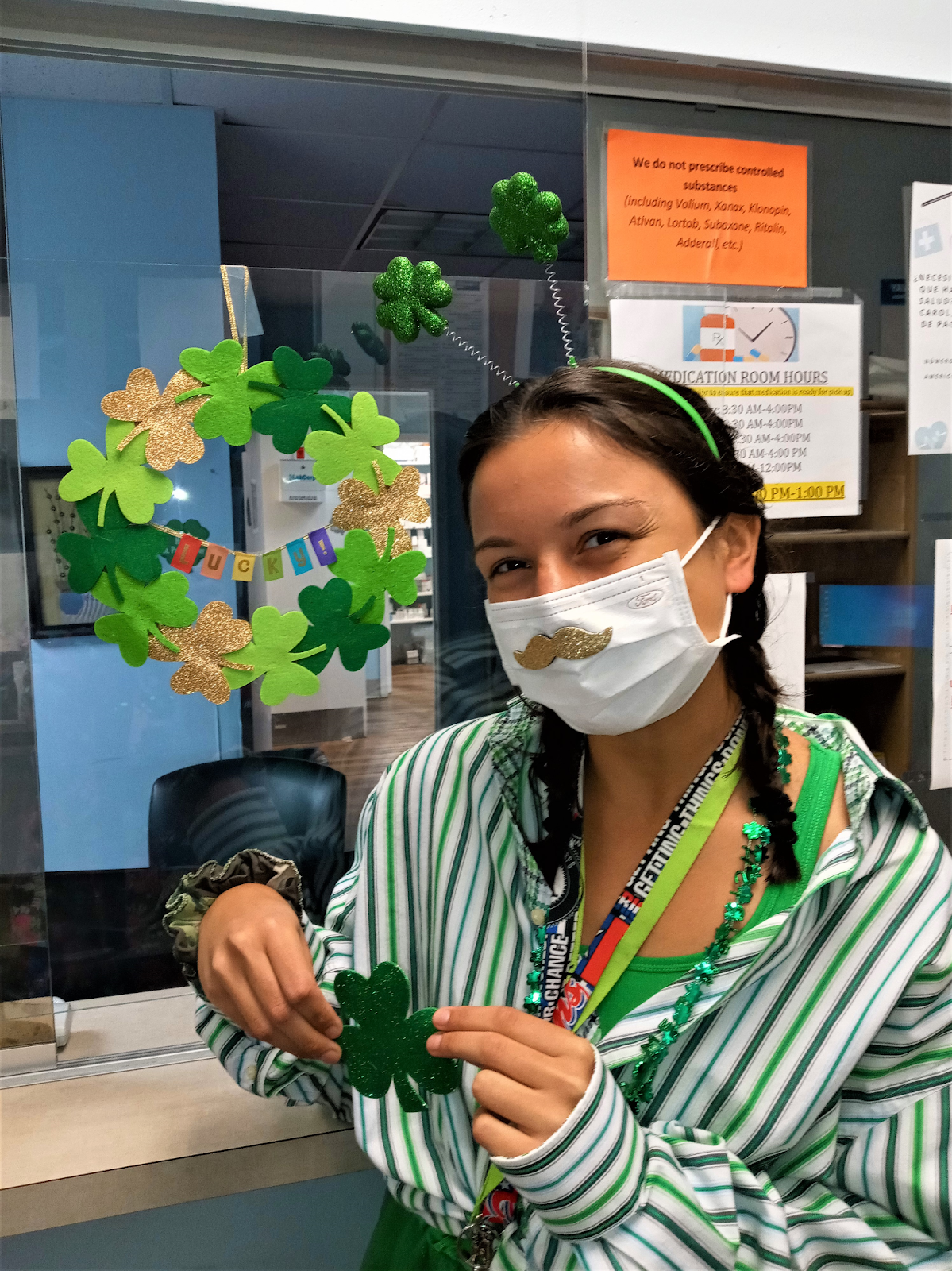 carol wearing a shamrock headband and surrounded by other st patricks day decor