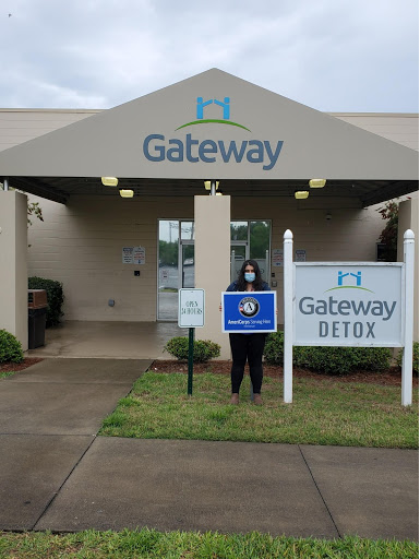 NHC member Roya stands outside the entrance to the Gateway Detox Building.