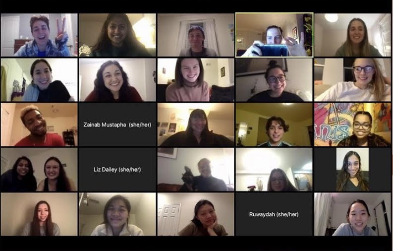 screen shot of a zoom call featuring a grid of smiling faces